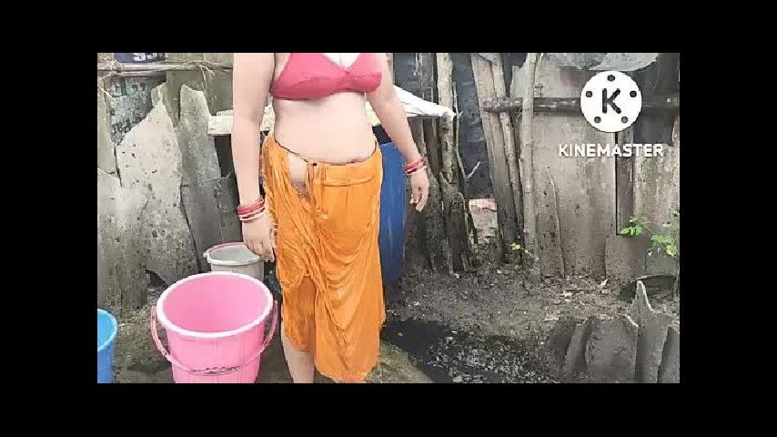 Indian house wife bathing outside