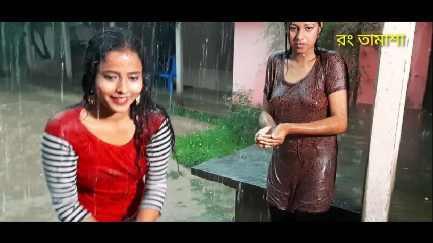 Two hot young girl enjoying in rain scene making